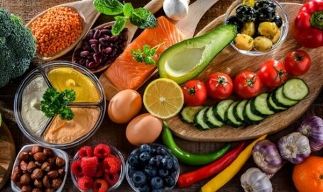 Ingredients of healthy diet including veggies, fruits, nuts, beans and more