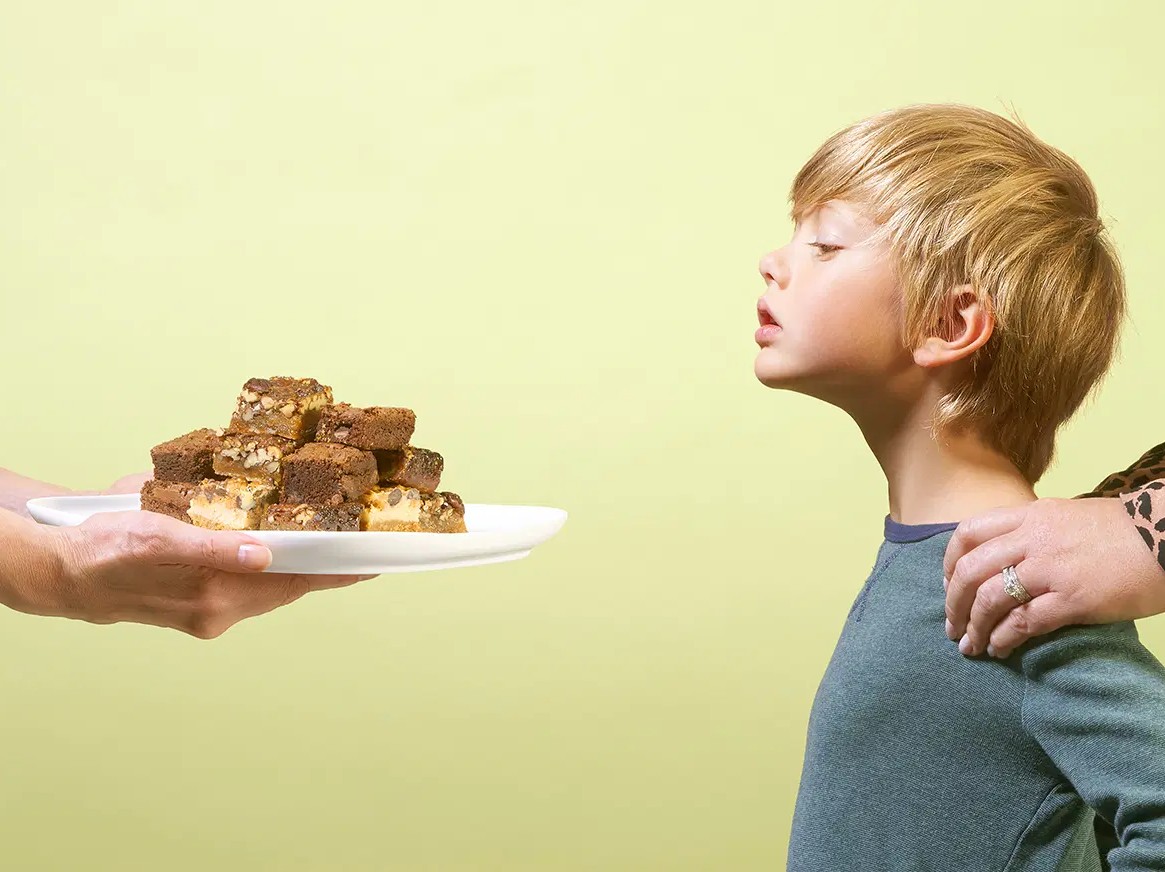 child eyeing brownies