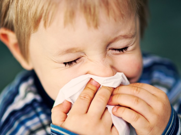child blowing nose