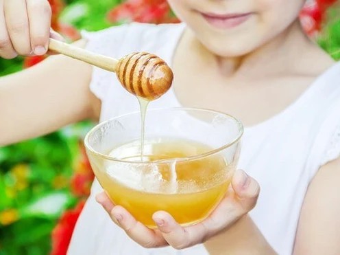 kid holding honey pot
