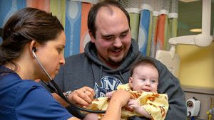 Children's Surgery Center nurse with father and baby