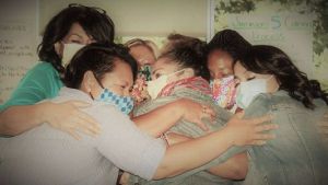 Nurses in a group embrace