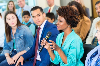 Group of people listening to one speaker