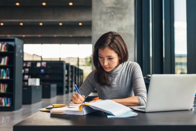 person working at a table in a library