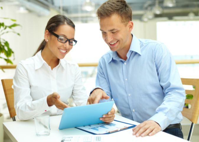 two people looking at a computer tablet