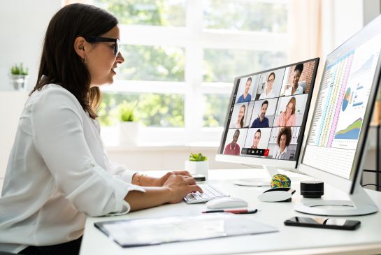 woman sitting in front of a computer monitor