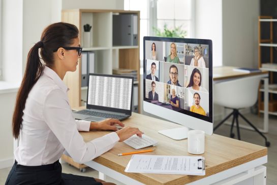 woman looking at a computer screen with multiple faces on it