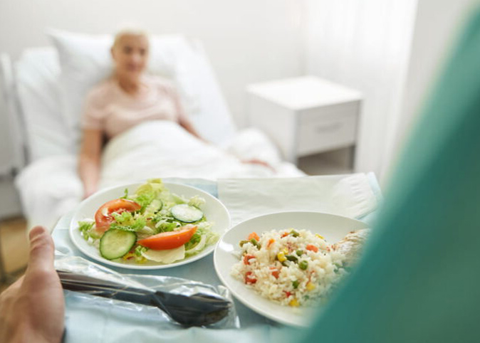 A hospital meal being deliverd to a patient.