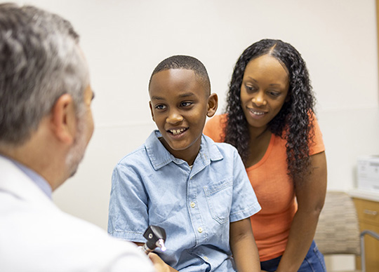 Doctor and pediatric patient with his mother