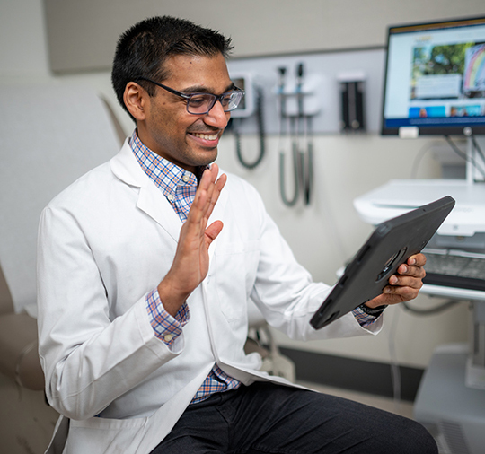 Doctor using an iPad during a video visit appointment
