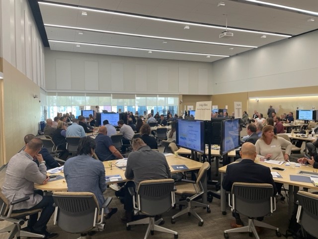 Attendees sit at tables during Industry Day