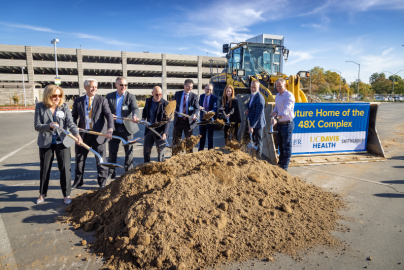 UC Davis Health administration and construction team members break ground on the site of the future 48X Complex.