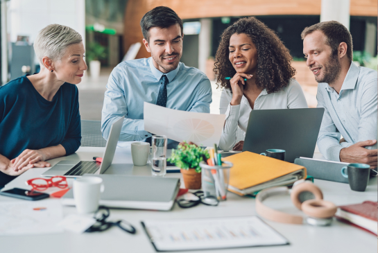 small group of people looking at a computer