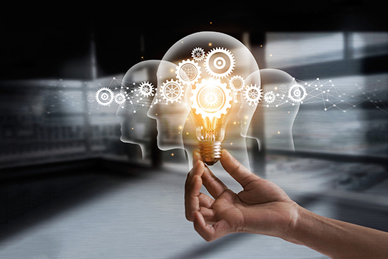 one hand holding the light bulb