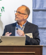 Anthony Jerant speaking behind a podium.