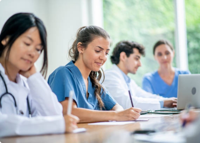 doctors in meeting taking notes