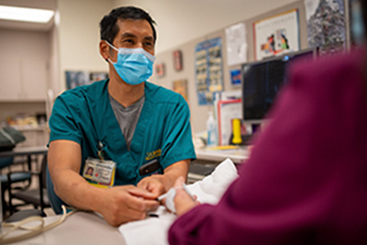 A healthcare worker speaking to a patient.