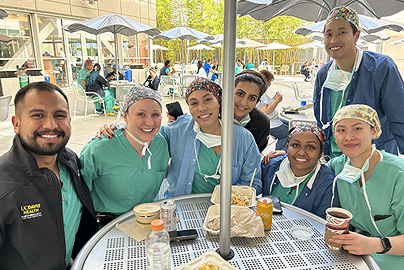 Group of doctors at an outdoor table.