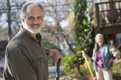 man raking in yard