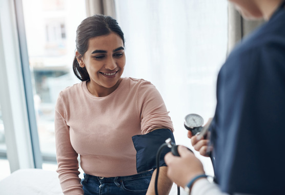 Blood pressure machine with an electrocardiogram graph line superimposed over the entire photograph. 
