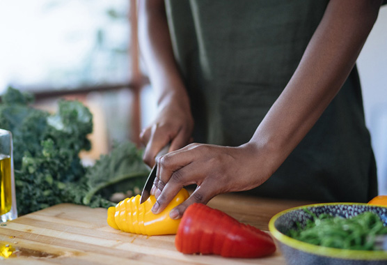 A person cutting vegetables.