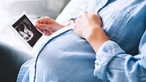 Mother holding ultrasound picture
