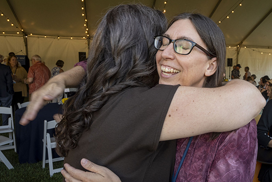 Class of 2005 alumni hugging.