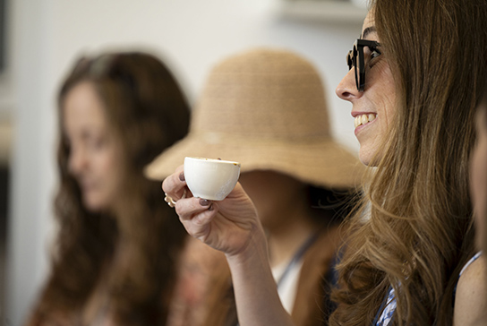 A woman with a coffee cup.