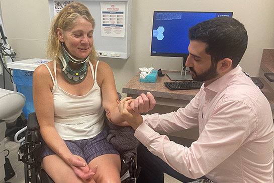 Patient in neck brace next to physical medicine and rehabilitation physician Shane Stone.