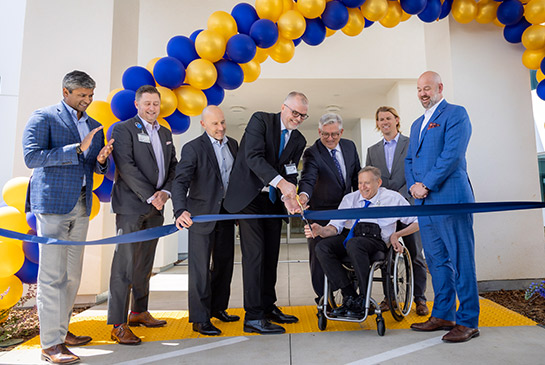 UC Davis team members cutting ribbon during the UC Davis Rehabilitation Hospital opening.