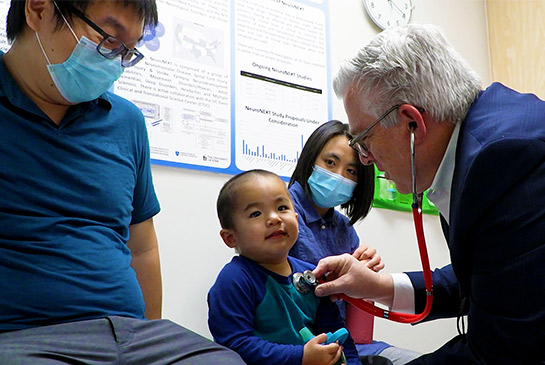Physical medicine and rehabilitation physician Craig McDonald, toddler patient and his parents.