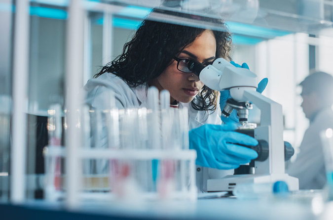 Researcher with microscope