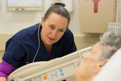 Healthcare worker speaking with an elderly patient
