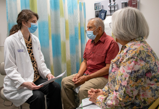 Gloved hand holding a microscope slide.