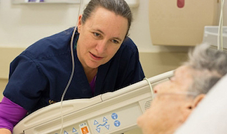 healthcare worker speaking with an elderly patient