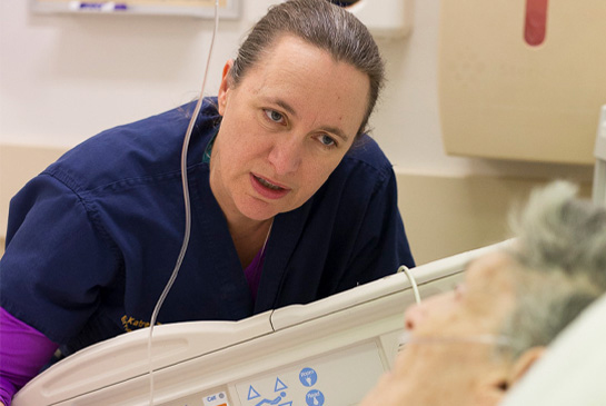 Healthcare worker speaking to a patient. 