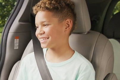 An older child using a seat belt.
