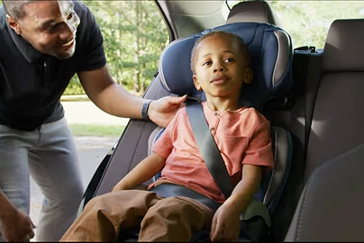 A child in a booster seat.