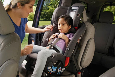 A child in a booster seat.
