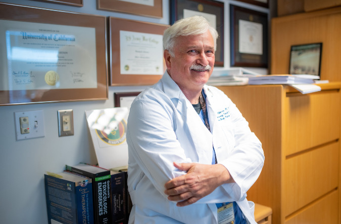 tim albertson smiling at camera in his office