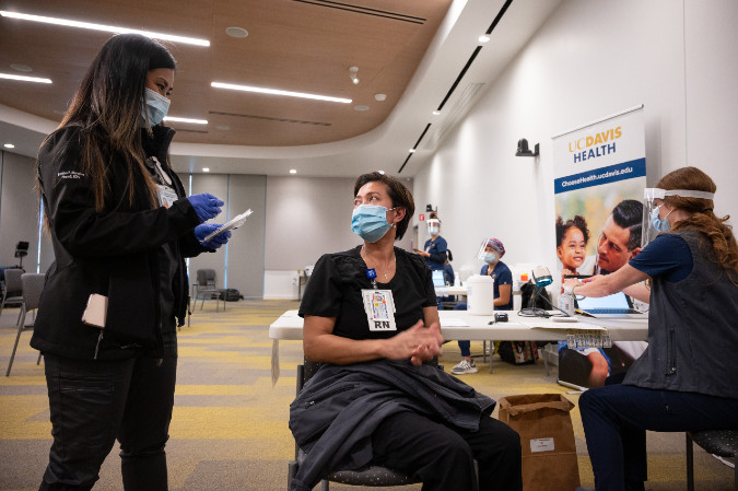 nurses talking to patient at clinic