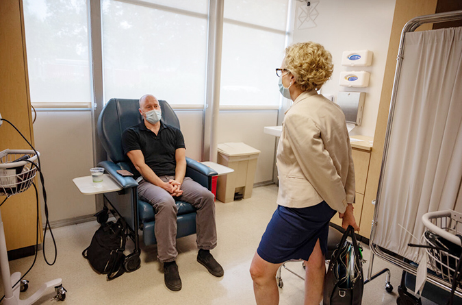 doctor speaking with patient in exam room