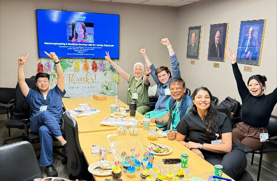 Fellows and faculty having fun during a meeting