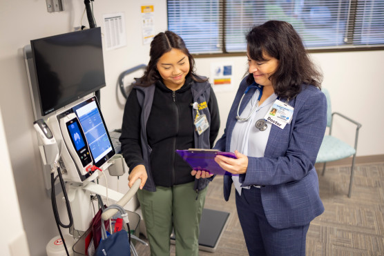 Physician and fellow in discussion.