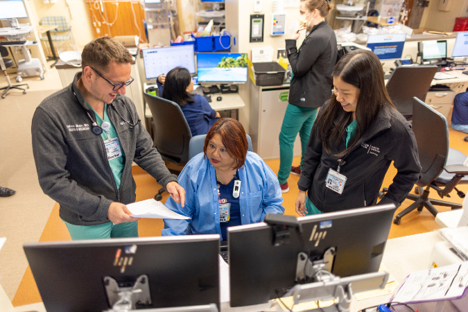 Nephrology doctors and healthcare workers in an office, discussing a patients case.