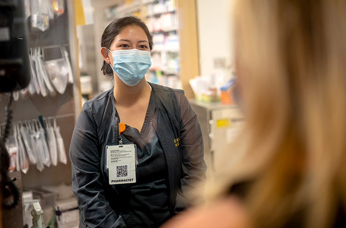 Pharmacist interacting with patient