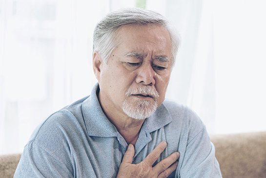 man clutching chest