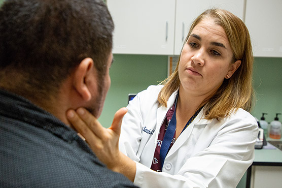 A team of nurses and doctors discussing around a desk