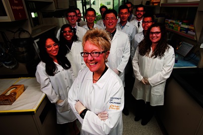 A group of researchers face the camera, with a female scientist featured in front