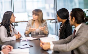 Group of people sitting at a conference table